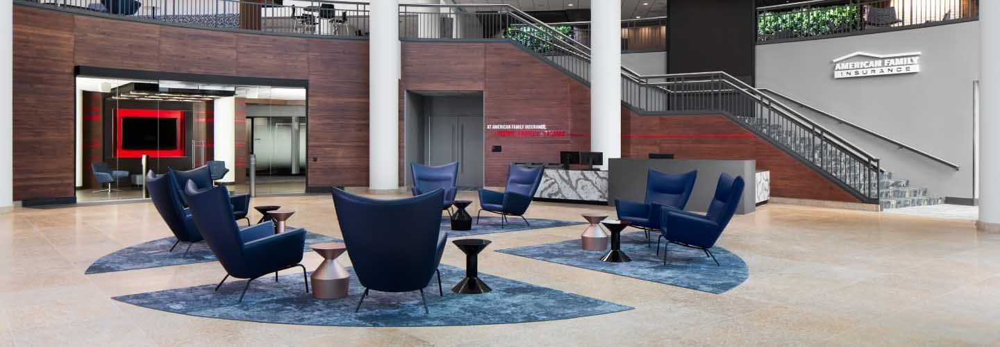 Trends in corporate office design includes use of a lobby to immediately establish corporate image and communicate brand. This space encourages visitors to view corproate materials and information presented on large video screens