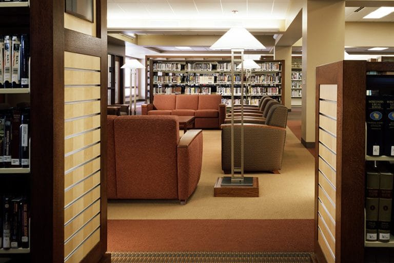 New Berlin Public Library Reading Area: A variety of reading areas were design that feature lounge seating and custom made bookshelves