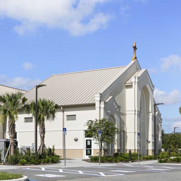 St. Catherine of Siena Catholic Church in Kissimmee, Florida integrates affordable construction techniques with references to traditional Architecture of the Catholic Church, including a cross at the highest point of the church.