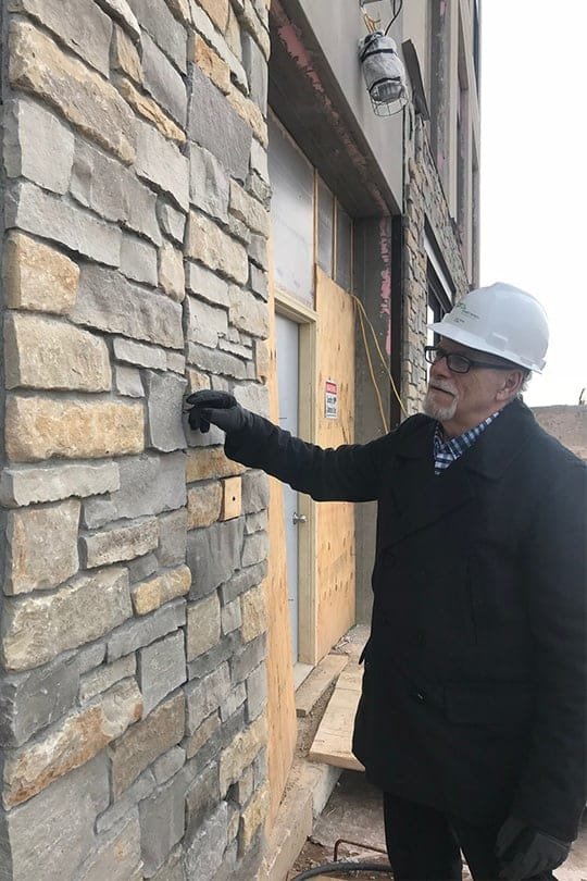 Construction Administration Architect Russel Owens evaluating masonry on a construction site in Wisconsin