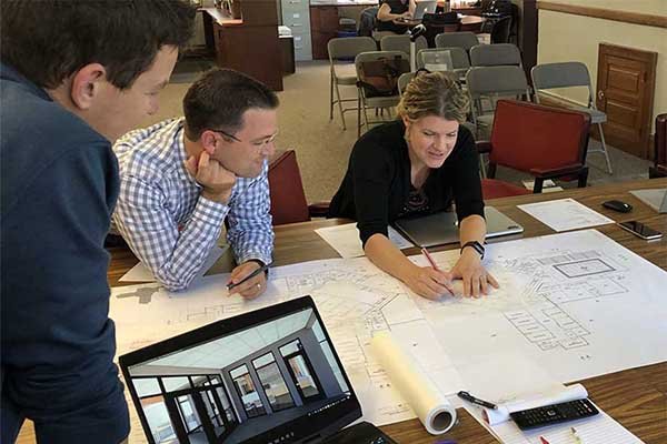 Education Architect Nicholas Kent and a design team work through school floor plans.